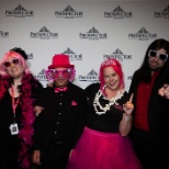 Prospects pose in sparkly pink attire in front of a branded step-and-repeat.