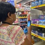 Employees use the camera on phones to scan products on display.