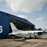 Mitsubishi MU2 on the runway in front of the hangar