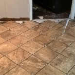 Remove water damaged laminate flooring, Prep concrete sub floor, Install tile in diamond pattern