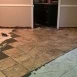 Remove water damaged laminate flooring, Prep concrete sub floor, Install tile in diamond pattern