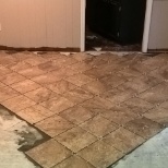 Remove water damaged laminate flooring, Prep concrete sub floor, Install tile in diamond pattern