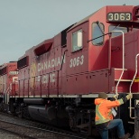 A Conductor climbs a locomotive.