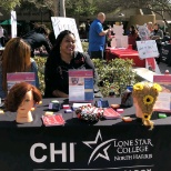 President of Cosmetology manning the Cosmo booth at the involvement fair.