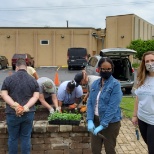 Sertoma Consumers open the guarden with staff and volunteers.