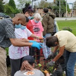 Sertoma Consumers open the guarden with staff and volunteers.