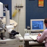 BWXT worker examining materials using a state of the art scanning electron microscope (SEM).