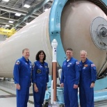 Behind the  astronauts in the photo above is one of the fuel tanks that make up the delta IV rocket